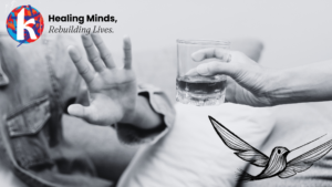 two people in a black and white photo that's cropped so you can only see their hands. One is offering an alcoholic drink in a rocks glass while the other hand is denying the offer.